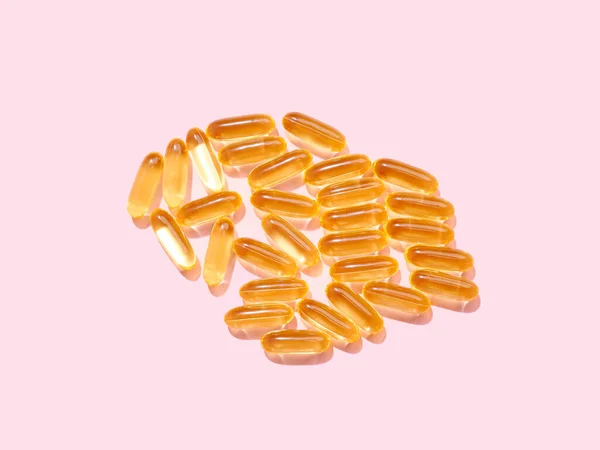 Omega Golden Translucent Pills Flat Pink Background Royalty Free Stock Images