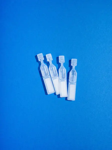 Eye Moisturising Drops Shape Small Pipettes Blue Background Royalty Free Stock Images