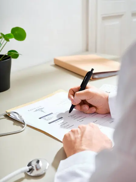 Anonymous Male Doctor White Gown Filling Out Medical Documentation Clinic Royalty Free Stock Images