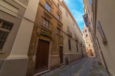 Arka planda Alghero katedrali olan dar bir sokak. Sardunya, İtalya