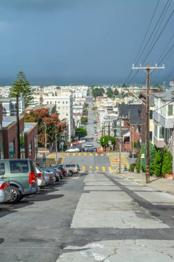 San Francisco 'da bulutlu bir gökyüzünün altında yokuş aşağı. Kaliforniya, ABD