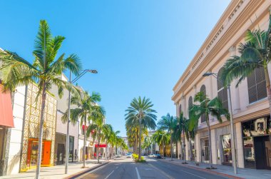 Beverly Hills 'teki ünlü Rodeo Drive' daki lüks mağazalar ve palmiye ağaçları. Los Angeles, Kaliforniya, ABD