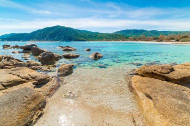 İlkbaharda kayalar ve turkuaz su. Sardunya, İtalya