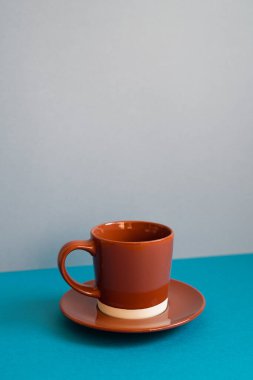Brown coffee cup on blue table
