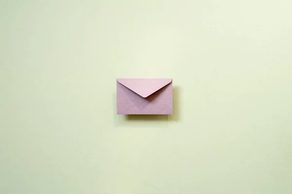 Purple envelope isolated on mint background. anniversary, valentine, birthday, christmas concept. top view, copy space