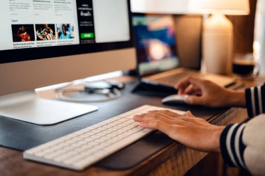 watching news on computer on table at home
