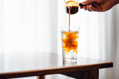 Iced coffee poured into a glass