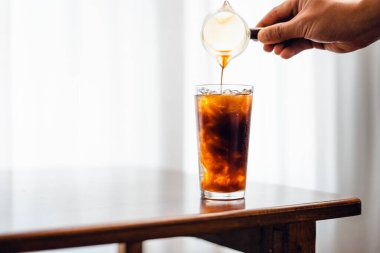 Iced coffee poured into a glass