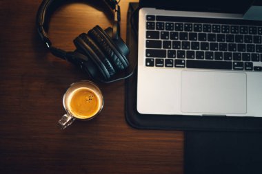 hot coffee on desk at home,coffee beside laptop