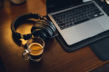 hot coffee on desk at home,coffee beside laptop