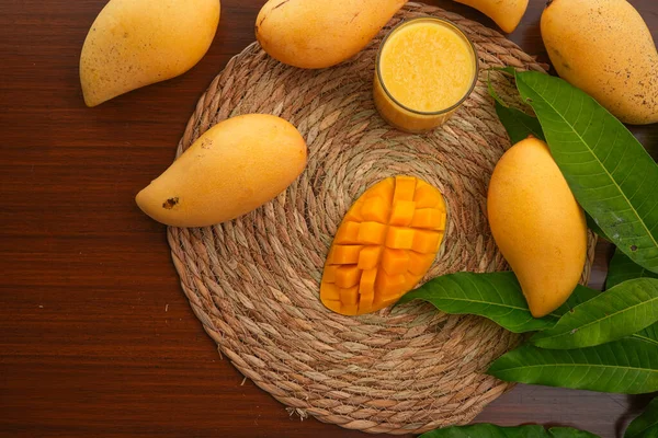 stock image Board with tasty fresh mango on wooden table