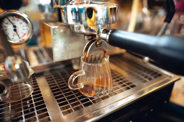Preparing coffee with coffee maker,Close up of coffee machine pouring coffee