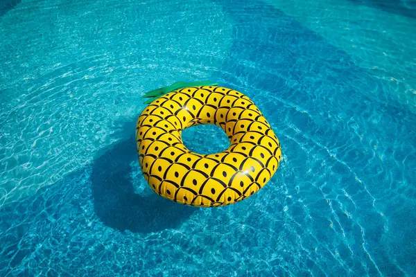 Yellow rubber ring floating in a blue pond on a summer day,summer time