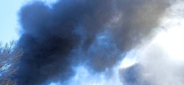 Smoke from fire on outskirts of the city after an air strike by Russian aircraft on the city. Horrors of war in Ukraine. Black smoke against sky. Fire during the war. Disaster