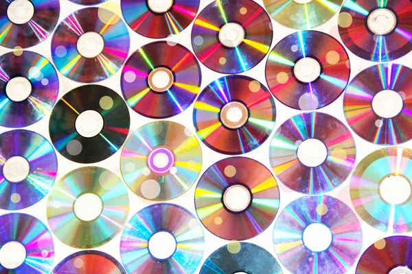 CDs pattern. Attributes of the 1990s. Memory entries. Video memory recording. Hobby of the 90s. Passion for music in the 1990s. Compact disks. Texture from CD