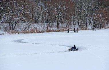 competitions of kart racing on the ice of Strizhen river in Chernihiv. sportsman driving go-cart at racing track on river ice. Pilot training go cartings. Racing kart training on race track.