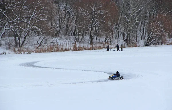 competitions of kart racing on the ice of Strizhen river in Chernihiv. sportsman driving go-cart at racing track on river ice. Pilot training go cartings. Racing kart training on race track.
