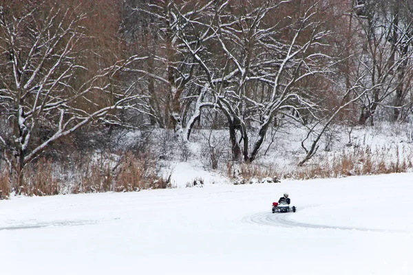 competitions of kart racing on the ice of Strizhen river in Chernihiv. sportsman driving go-cart at racing track on river ice. Pilot training go cartings. Racing kart training on race track.