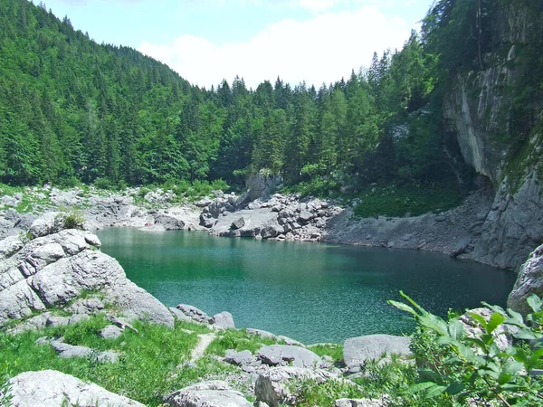 Beautiful lake among mountain rocks. Mountain lake. Landscape with lake in mountain valley.