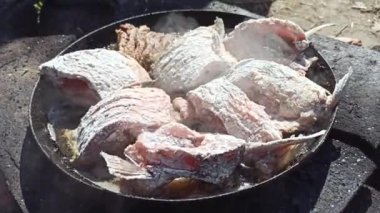 Balık kızartma tavasında kızarır. Taze balık yakalıyorum. Başarılı bir balık avı. Ateşte kızartılmış lezzetli balık yemeği. Kızarmış balığın tabağı ateşte pişiyor. İyi istirahatlar. Balık kızartma parçaları.