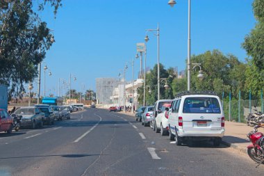 Hurghada - Mısır. 30 Temmuz 2018: Hurghada 'daki binalarla ilgili sokak arabalı şehir panoraması. Hurghada 'da karayolu üzerinde ulaşım ve trafik. Mısır şehri Hurghada 'da işlek bir cadde. Afrika kasabası,