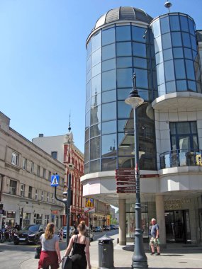 Lodz - Polonya. 17 Ağustos 2019: Dikdörtgen şeklinde dev cam pencereli büyük koyu gri bina. Lodz 'da modern mimari. Koyu cam pencereli bina. Şehirde cam cepheli modern bir bina. Ofis binası