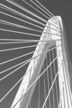 a abstract image of the metal cables of a suspension bridge black and white