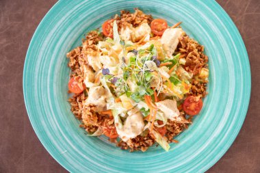 a view over a plate of mediterranean chicken Caeser salad close up clipart