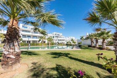 an image of the community gardens and swimming pool of a luxury mediterranean holiday home urbanization 