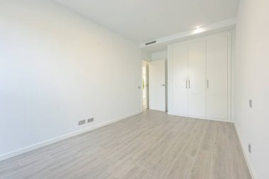 Beyaz duvarları olan boş bir yatak odası resmi ve Akdeniz tatil gayrimenkullerinde gardıroplar. 