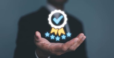 Businessman Hand shows the sign of the top service the best Quality assurance, Guarantee, Standards, ISO certification and standardization concept. guarantee product and ISO service concept.