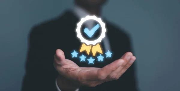 Businessman Hand shows the sign of the top service the best Quality assurance, Guarantee, Standards, ISO certification and standardization concept. guarantee product and ISO service concept.