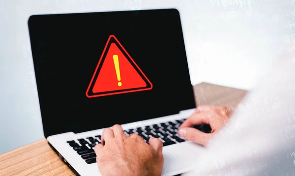 Businessman or it staff , programmer, developer using computer laptop with triangle caution warning sign for notification error and maintenance concept.