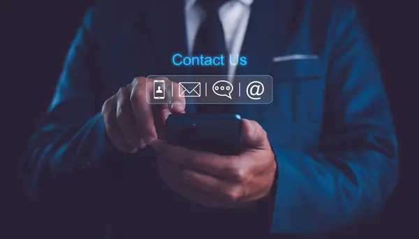 Contact us or Customer support hotline people connect. Businessman using a mobile phone with the email, call phone, address, Chat message icons.	