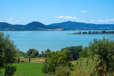 The Trasimeno lake at summer near Torricella and Monte del Lago, in Perugia province, Umbria, Italy clipart