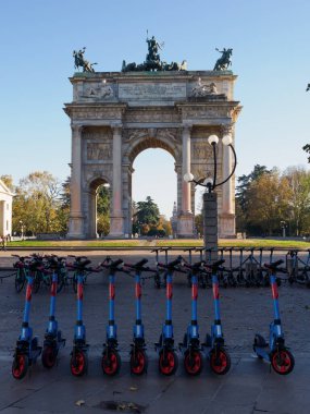 The historic Arco della Pace with scooters in Milan, Lombardy, Italy clipart