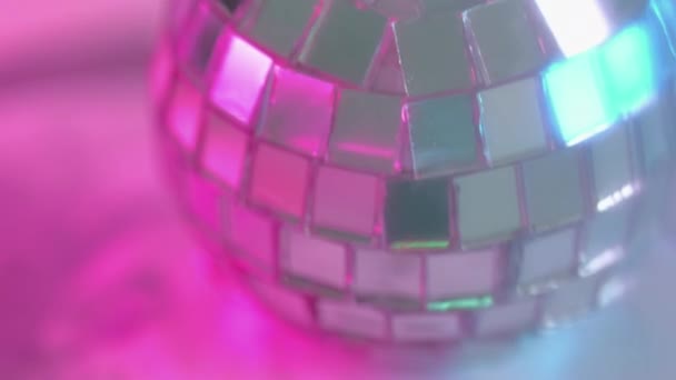 ディスコパーティー ナイトクラブの装備 現代のお祝いの装飾的な銀の光沢のある円形のミラー ボールは魅力的な雰囲気のネオン ピンクのライトで回ります — ストック動画