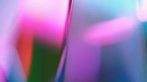 Prism background. Rays refraction. Crystal reflection. Defocused blue pink fluorescent light radiance illumination glow