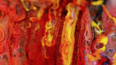 Parlak mürekkep akışı. Boya karışımı. Odaklanmamış parlak kırmızı renk parıldayan parçacıklar doku sıvısı harman dalga hareketi soyut sanat arka planı.