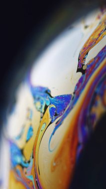 Boya karışımı. Holografik küre. Odaklanmamış mavi turuncu renk lekesi yağ sıvısı mürekkep karışım dalga mermer dokusu koyu siyah soyut sanat arka planında.