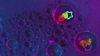 Işıldayan mürekkep arka planı. Işıl ışıl. Dekoratif sıvı. Floresan mavi pigment hava kabarcıkları parlak yaratıcı pullarla soyut hareket eder..