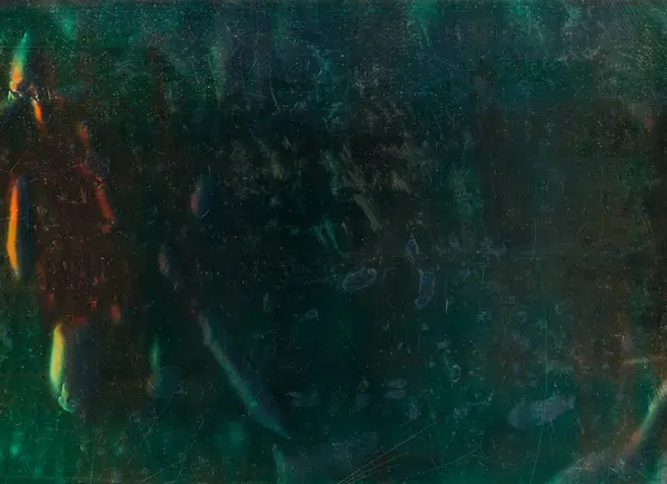 Distressed texture. Old film overlay. Wet stains. Green red blue dust scratches bubbles defect weathered uneven surface dark grunge illustration abstract background.