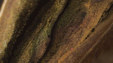 Parıltılı boya döküldü. Mermer dokusu. Odaklanmamış altın sarısı siyah renk ışıl ışıl sıvı karışımı dalga hareketi soyut sanat arkaplanı.