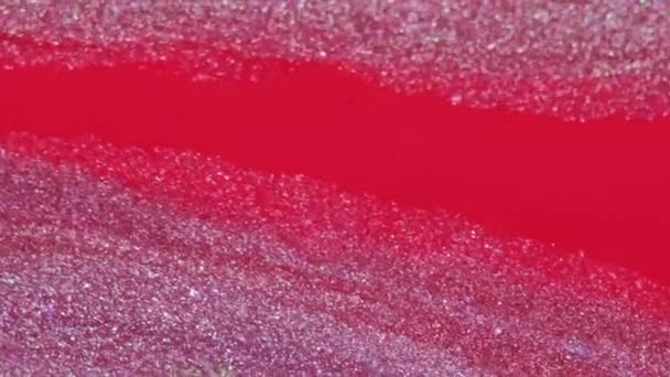 スパークリング液 グリッターペイントテクスチャー ピンクの赤い色光沢のある金属インク水こぼれミックス波動の背景抽象フリースペース — ストック動画