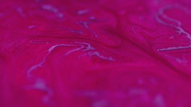 Boya karışımı. Parıldayan sıvı dökülmüş. Odaklanmamış neon pembe renkli simli akrilik mürekkep karışımı hipnotik akış yayıyor soyut sanat arka planı.