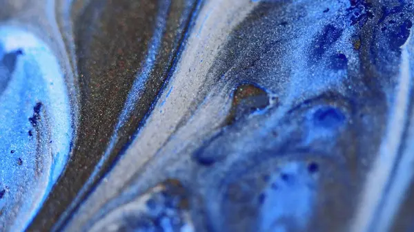 Glitter fluid drip. Ink spill. Blur blue bronze white color metallic texture paint emulsion gloss wave glamour abstract art background.