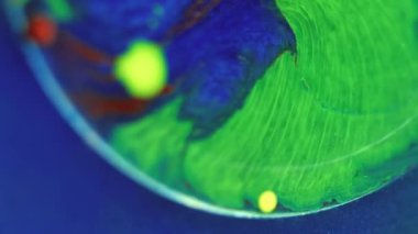 Soyut arkaplan. Sıvı sanat dokusu. Yağlı sıvı leke. Renkli yeşil kırmızı mavi lekeli şeffaf yağ lekesi sim parçacıkları yüzeyine yayılıyor..