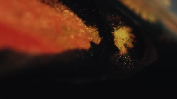 Glitter Ink Flow Sparkling Fluid Defocused Black Gold Orange Color — Stock Video