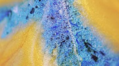 Soyut arkaplan. Pigment karışımı. Renkli dökülme. Makro sanatta yüzeye yayılan siyah leke pürüzsüz madde içeren yaratıcı parlak sarı simler..