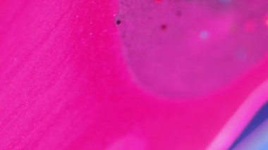 Dikey video. Göz kamaştırıcı bir geçmişi var. Parıltı karışımı. Soyut sanat. Odaklanamayan pembe mor sıvı karışımı. Yuvarlak parçacıklar, güzel hareketler..